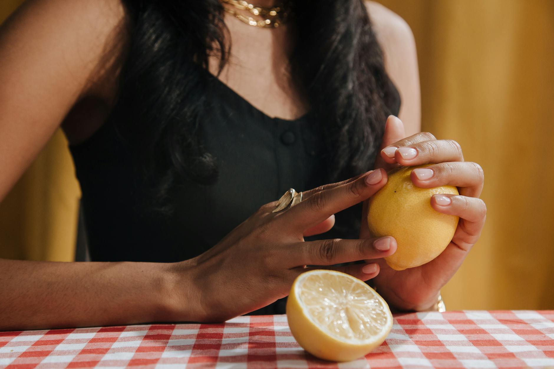Two hands holding colorful silicone vibrators, demonstrating the variety of clitoral stimulation tools available.