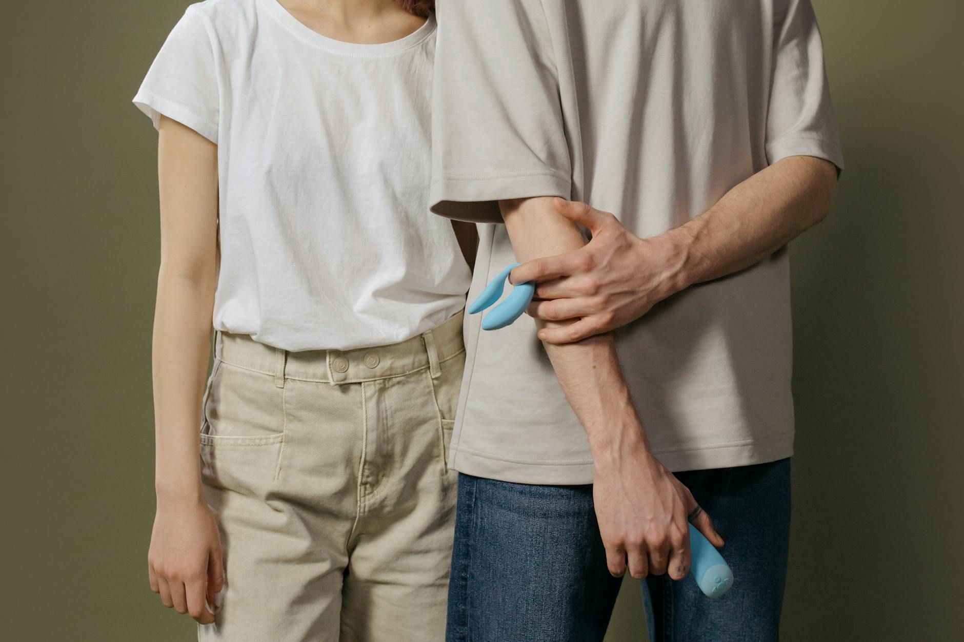 A couple standing together indoors, exploring intimacy together with modern tools
